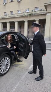 House of Sinn chauffer holding door for Mistress Ayn