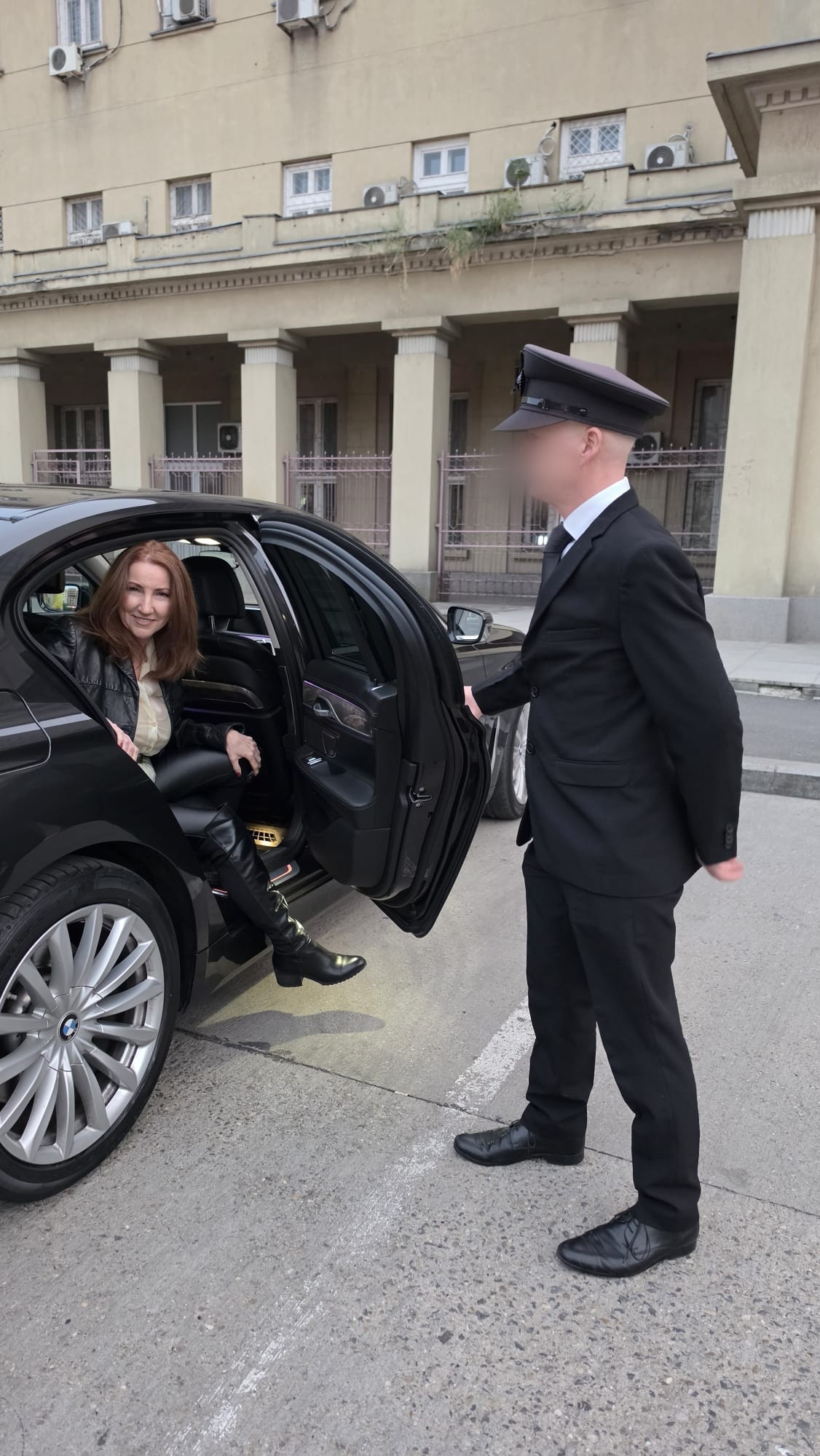 House of Sinn chauffer holding door for Mistress Ayn